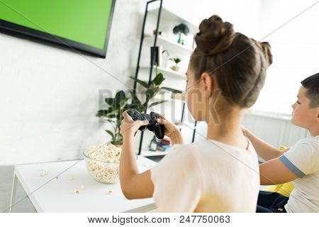 Pre-adolescent Children Playing Video Game At Home