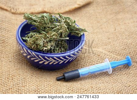 Hash Oil Phoenix Tears Medicine In Little Syringe With Dry Marijuana Buds