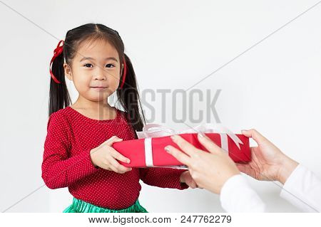 Attractive Asian Girl Received A Present At Brithday With Her Family. Kid Holding Gift With Attracti