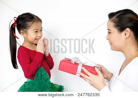 Attractive Asian Girl Received A Present At Brithday From Her Mom. Kid Holding Gift With Attractive 