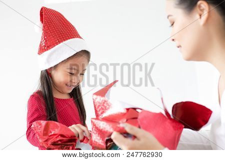 Attractive Asian Girl Received A Present At Brithday With Her Family. Kid Holding Gift With Attracti