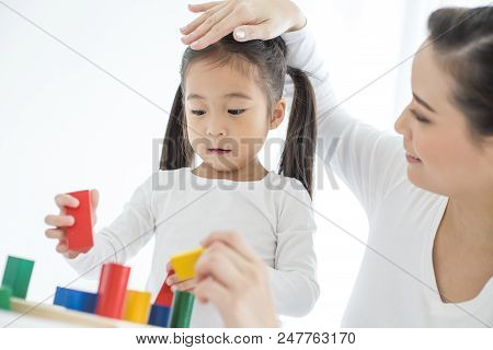 Mam Playing Toy With Her Daugther At Home. Happy Family Concept.