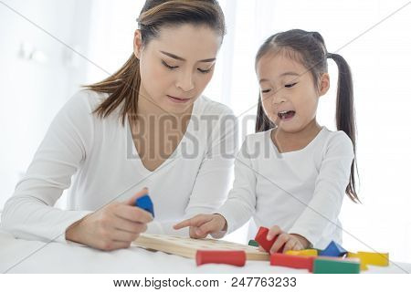 Mam Playing Toy With Her Daugther At Home. Happy Family Concept.