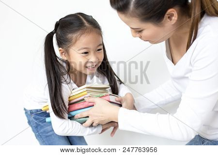 Attractive Little Girl Holding Book With Smiling. Happy Children Lifestyle, Education Concept.