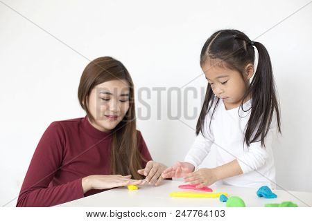 Woman Playing Toy With Kid At Home. Happy Family Concept.