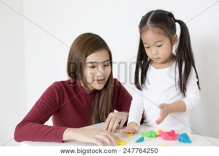 Woman Playing Toy With Kid At Home. Happy Family Concept.