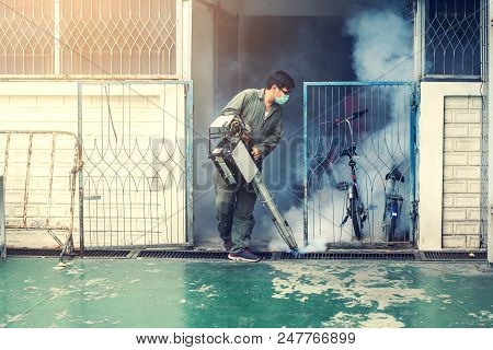 Man Work Fogging To Eliminate Mosquito For Preventing Spread Dengue Fever And Zika Virus