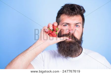 Fresh Juice Concept. Man Drinks Strawberry Juice Suck Thumb As Drink Straw Blue Background. Hipster 