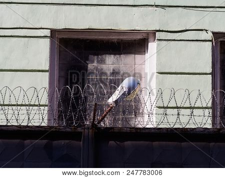 Lantern On The Fence. The Lantern Is Behind Barbed Wire