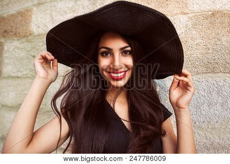 Stylish Young Woman Wearing Classic Fashionable Outfit Against Stone Wall. Beautiful Model In Luxuri