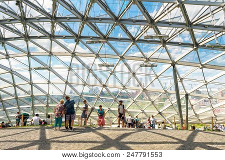 Moscow - June 17, 2018: People Visit A Modern Amphitheater With Glass Dome In Zaryadye Park Near Mos