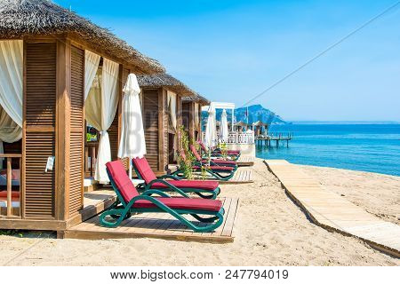 Antalya, Turkey - 9 May 2018: Wooden Beach Pavilions On The Shore Of A Sandy Beach - The Mediterrane