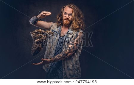 Portrait Of A Tattoed Redhead Hipster Male With Long Luxuriant Hair And Full Beard Dressed In A T-sh