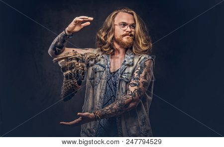 Portrait Of A Tattoed Redhead Hipster Male With Long Luxuriant Hair And Full Beard Dressed In A T-sh