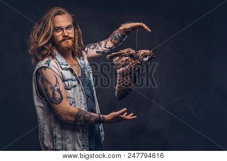 Portrait Of A Tattoed Redhead Hipster Male With Long Luxuriant Hair And Full Beard Dressed In A T-sh