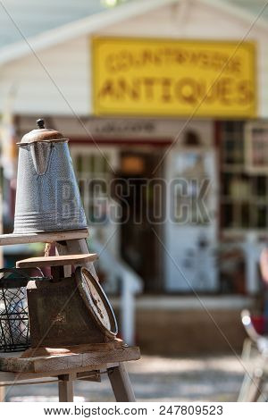 Braselton, Ga - April 28:  Antique Coffee Pourer And Scale Are Displayed For Sale On Wooden Stepladd