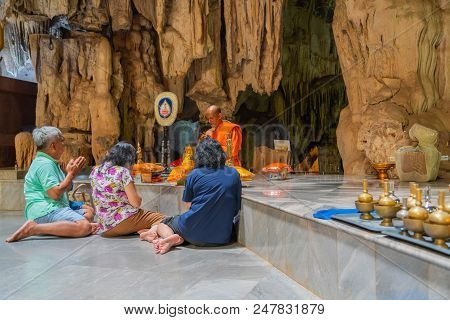 Kanchanaburi, Thailand - May 13, 2018: Group Of People Making Merit By Offering Things To Buddhist M