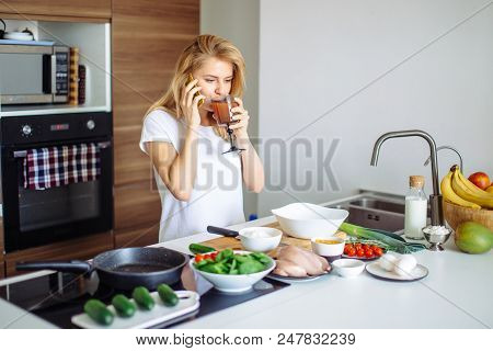 Young Housewife Is Going To Make Delicious Dish, Phoning To Her Mother To Learn Receipt In Her Styli