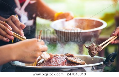 People Cooking Meat And Grill. Food Are Vegeteble. People Use Chopsticks.