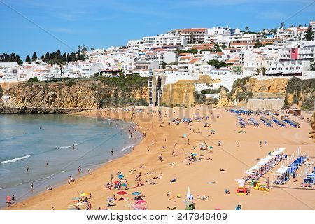 Albufeira, Portugal - June 10, 2017 - Elevated View Of The Beach And Town With People Enjoying The S