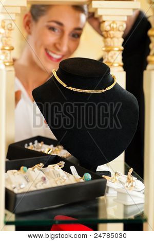 Mujer en la joyería está buscando joyas