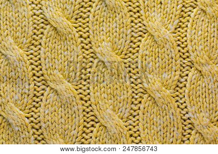 Knit Texture Of Yellow Wool Knitted Fabric With Regular Cable Knits Pattern As Background