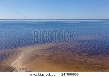 Sandy Shoreline And Sandbanks In The Water.