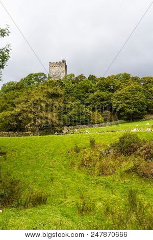 Castle Or Castell Dolwyddelan From Distance With Fields In Foreground, Copyspace.