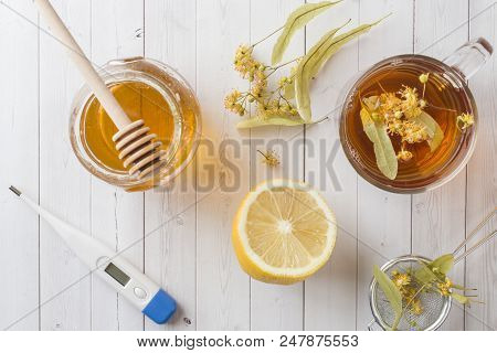 Tea With Linden, Honey And Lemon. Healthy Food, Treatment Of Colds Thermometer On The Table