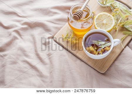 Tea With Linden, Honey And Lemon. The Tray On The Bed, The Concept Of The Treatment Of Colds