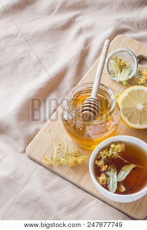 Tea With Linden, Honey And Lemon. The Tray On The Bed, The Concept Of The Treatment Of Colds