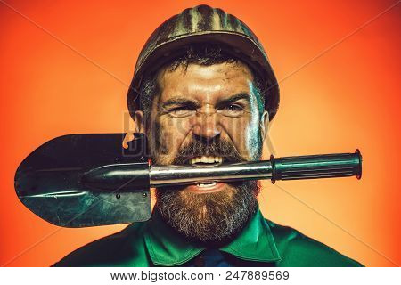 Industrial Worker Protective Helmet With Spade. Builder, Construction Worker With Spade. Man In Hard