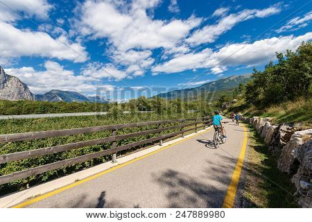 Bicycle Path With Cyclists In The Sarca Valley (valle Del Sarca). Trentino Alto Adige, Italy, Europe
