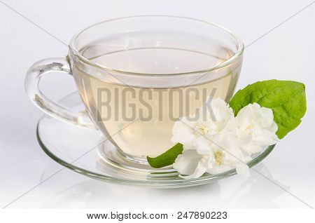 Glass Cup Of Tea With Jasmine Flowers And Leaves