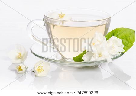 Glass Cup Of Tea With Jasmine Flowers And Leaves