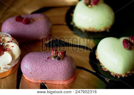 Moscovie Cakes Purple And Lemon Yellow. Pistachio And Fruit. Culinary Art. Gold Leaf Monstera