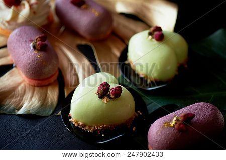 Moscovie Cakes Purple And Lemon Yellow. Pistachio And Fruit. Culinary Art. Gold Leaf Monstera