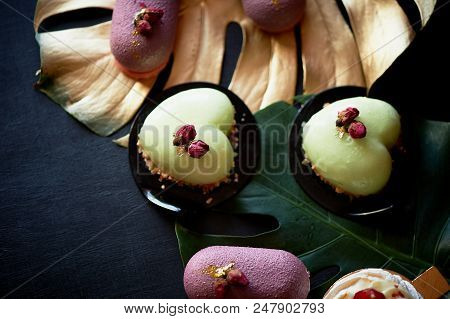 Moscovie Cakes Purple And Lemon Yellow. Pistachio And Fruit. Culinary Art. Gold Leaf Monstera