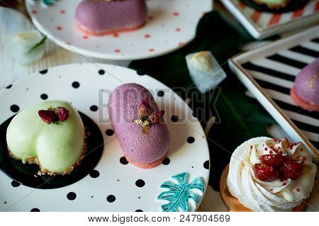Moscovie Cakes Purple And Lemon Yellow. Pistachio And Fruit. Meringue Anna Pavlova . Culinary Art. O