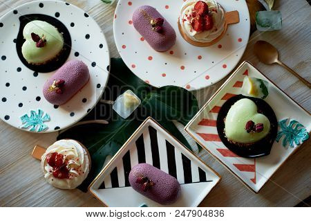 Moscovie Cakes Purple And Lemon Yellow. Pistachio And Fruit. Meringue Anna Pavlova . Culinary Art. O