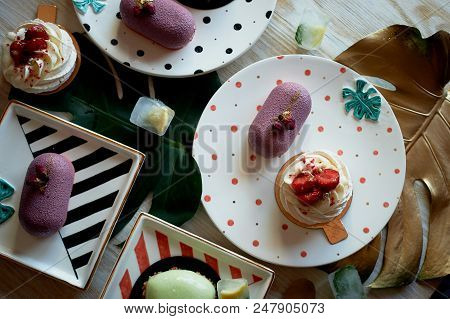 Moscovie Cakes Purple And Lemon Yellow. Pistachio And Fruit. Meringue Anna Pavlova . Culinary Art. O