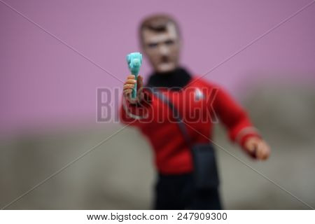 JUNE 30 2018: Recreation of a scene from Star Trek original television series where Red Shirt Lieutenant Leslie points his phaser at the enemy - Mego inspired custom action figure