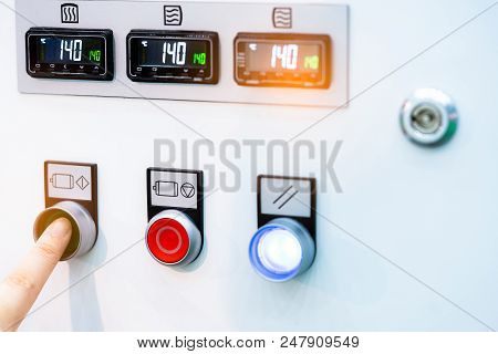 Engineer's Hand Push Green Button To Open Temperature Control Machine. Temperature Control Panel Cab