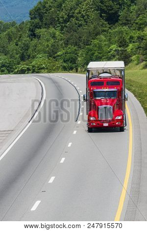 A Lone Red 18-wheeler Travels A Tennessee Interstate. Note: All Logos And Identifying Marks Removed 