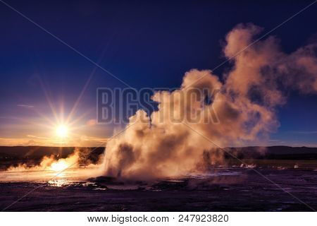 Clepsydra geyser in Yellowstone National Park in Wyoming erupts almost continuously and is beautiful at sunset.  It is located in the Lower geyser basin.