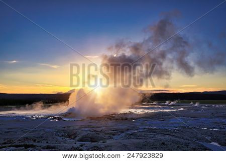 Clepsydra geyser in Yellowstone National Park in Wyoming erupts almost continuously and is beautiful at sunset.  It is located in the Lower geyser basin.