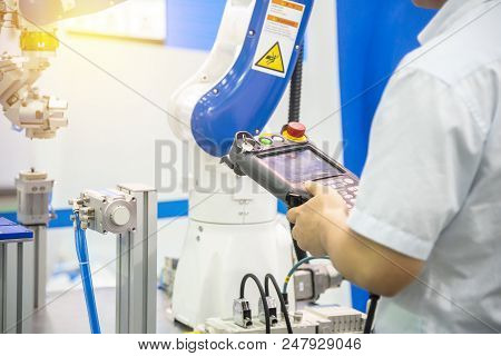 The Engineer Control The Robotic Arm For Manufacturing Process.hi-technology For Manufacturing  Proc