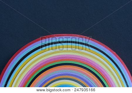 Clolored Stripes Of Paper For Quilling Arranged In A Semi-cricle On Dark Blue Background