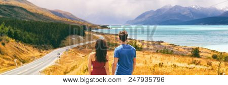New Zealand travel people looking at Mount Cook Aoraki far in the landscape. Couple tourists walking at Peter's lookout, banner panorama copy space on background.