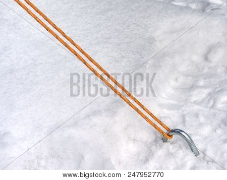 Rope On A Camp Tent, Detail Of Anchored Tent In Snowy Ground Within Extreme Mountain Trail.